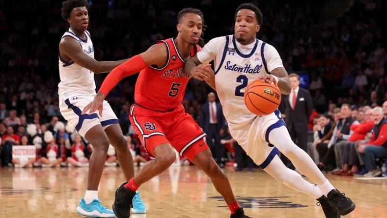 Mar 14, 2024; New York City, NY, USA; Seton Hall Pirates guard Al-Amir Dawes (2) drives to the basket against St. John's Red Storm guard Daniss Jenkins (5) during the second half at Madison Square Garden. Mandatory Credit: Brad Penner-USA TODAY Sports