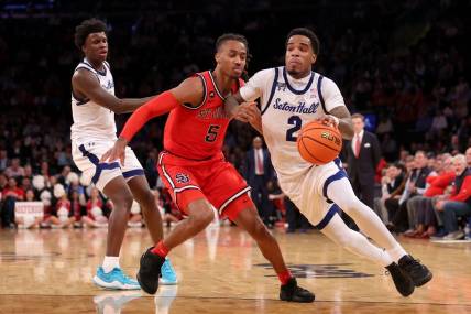 Mar 14, 2024; New York City, NY, USA; Seton Hall Pirates guard Al-Amir Dawes (2) drives to the basket against St. John's Red Storm guard Daniss Jenkins (5) during the second half at Madison Square Garden. Mandatory Credit: Brad Penner-USA TODAY Sports