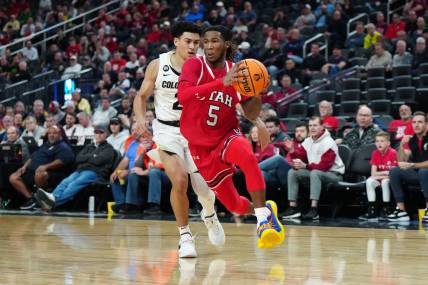 Mar 14, 2024; Las Vegas, NV, USA; Utah Utes guard Deivon Smith (5) drives to the basket against Colorado Buffaloes guard KJ Simpson (2) in the first half at T-Mobile Arena. Mandatory Credit: Kirby Lee-USA TODAY Sports