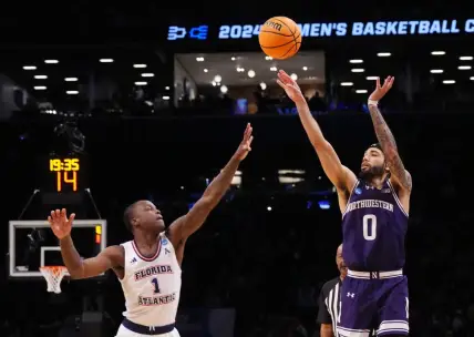March 22, 2024, Brooklyn, NY, USA; Northwestern Wildcats guard Boo Buie (0) shoots over Florida Atlantic Owls guard Johnell Davis (1)  in the first round of the 2024 NCAA Tournament at the Barclays Center. Mandatory Credit: Robert Deutsch-USA TODAY Sports