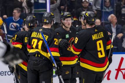 Mar 25, 2024; Vancouver, British Columbia, CAN;  Vancouver Canucks defenseman Quinn Hughes (43), forward Nils Hoglander (21), forward Brock Boeser (6), forward J.T. Miller (9) and forward Elias Pettersson (40) celebrate Boeser’s goal against the Los Angeles Kings in the third period at Rogers Arena. Kings won 3 -2. Mandatory Credit: Bob Frid-USA TODAY Sports
