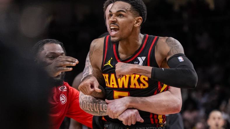 Mar 28, 2024; Atlanta, Georgia, USA; Atlanta Hawks guard Dejounte Murray (5) reacts after making a go ahead basket with less than a second left against the Boston Celtics during overtime at State Farm Arena. Mandatory Credit: Dale Zanine-USA TODAY Sports