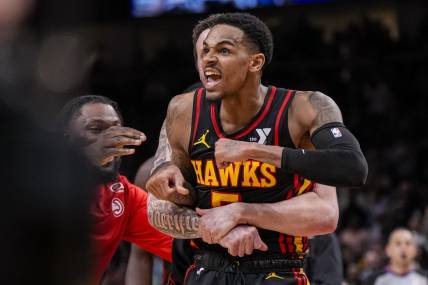 Mar 28, 2024; Atlanta, Georgia, USA; Atlanta Hawks guard Dejounte Murray (5) reacts after making a go ahead basket with less than a second left against the Boston Celtics during overtime at State Farm Arena. Mandatory Credit: Dale Zanine-USA TODAY Sports