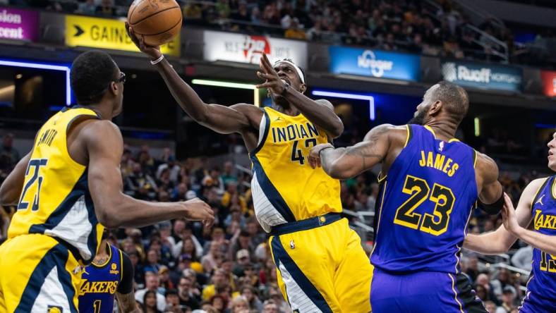 Mar 29, 2024; Indianapolis, Indiana, USA; Indiana Pacers forward Pascal Siakam (43) shoots the ball while Los Angeles Lakers forward LeBron James (23) defends in the first half at Gainbridge Fieldhouse. Mandatory Credit: Trevor Ruszkowski-USA TODAY Sports