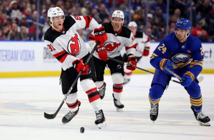 Mar 29, 2024; Buffalo, New York, USA;  Buffalo Sabres center Dylan Cozens (24) watches as New Jersey Devils center Dawson Mercer (91) makes a pass during the third period at KeyBank Center. Mandatory Credit: Timothy T. Ludwig-USA TODAY Sports