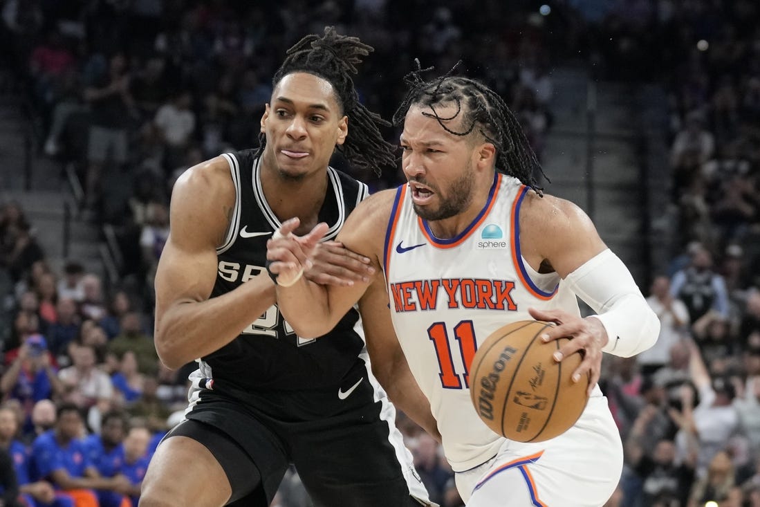 Mar 29, 2024; San Antonio, Texas, USA; New York Knicks guard Jalen Brunson (11) drives to the basket while defended by San Antonio Spurs guard Devin Vassell (24) during overtime at Frost Bank Center. Mandatory Credit: Scott Wachter-USA TODAY Sports