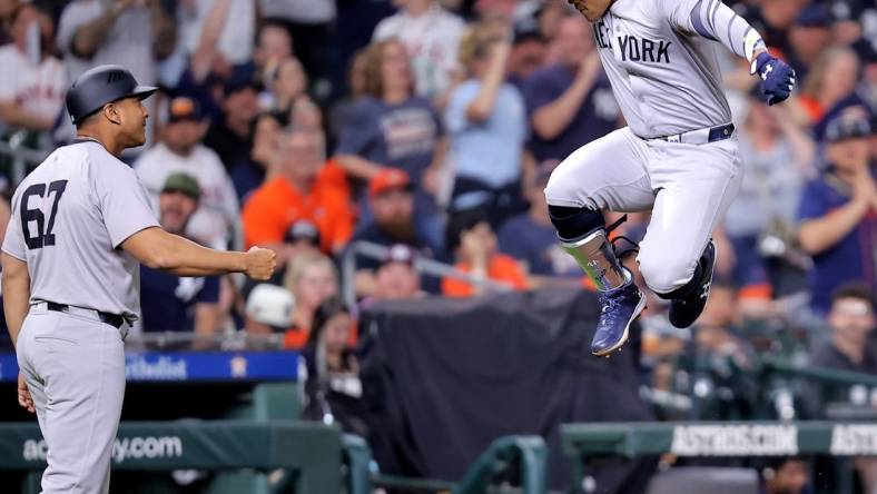 Mar 30, 2024; Houston, Texas, USA; New York Yankees right fielder Juan Soto (22, right) reacts after hitting a home run to left field against the Houston Astros during the seventh inning at Minute Maid Park. Mandatory Credit: Erik Williams-USA TODAY Sports