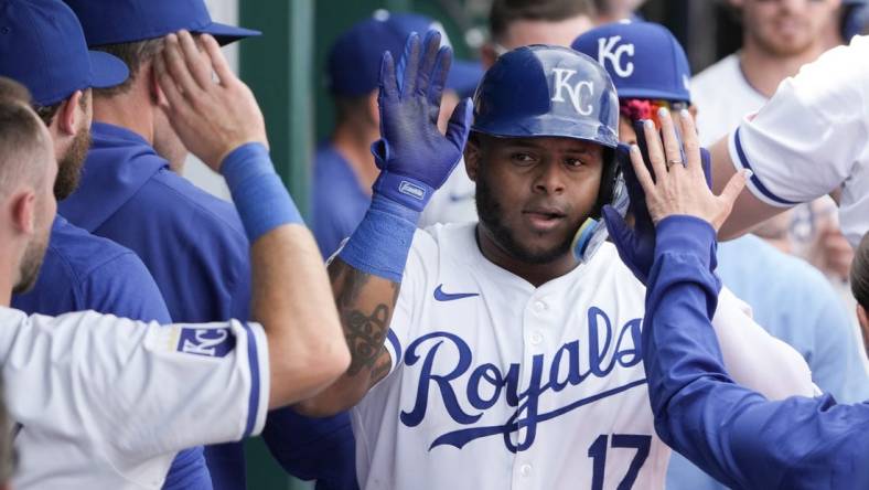 Mar 31, 2024; Kansas City, Missouri, USA; Kansas City Royals right fielder Nelson Velazquez (17) is congratulated in the dugout against the Minnesota Twins after hitting a solo home run in the sixth inning at Kauffman Stadium. Mandatory Credit: Denny Medley-USA TODAY Sports