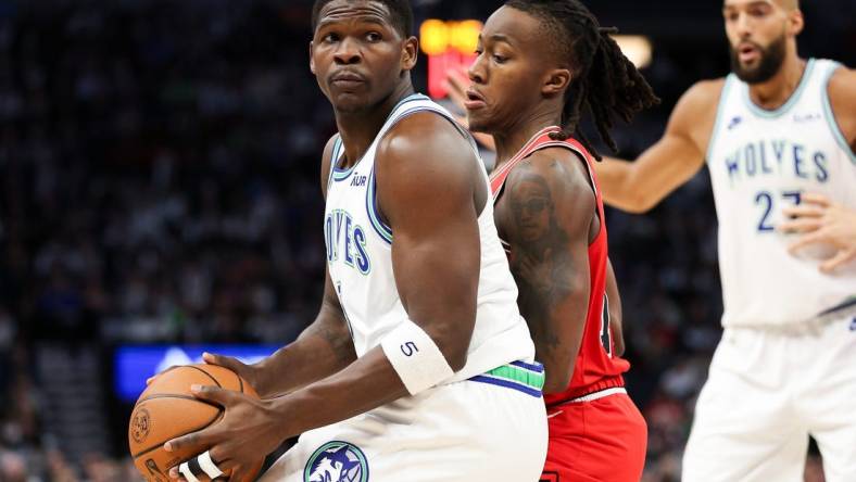 Mar 31, 2024; Minneapolis, Minnesota, USA; Minnesota Timberwolves guard Anthony Edwards (5) works around Chicago Bulls guard Ayo Dosunmu (12) during the first half at Target Center. Mandatory Credit: Matt Krohn-USA TODAY Sports