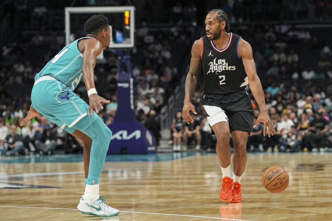 Mar 31, 2024; Charlotte, North Carolina, USA; LA Clippers forward Kawhi Leonard (2) on the dribble against Charlotte Hornets forward Brandon Miller (24) during the second half at Spectrum Center. Mandatory Credit: Jim Dedmon-USA TODAY Sports