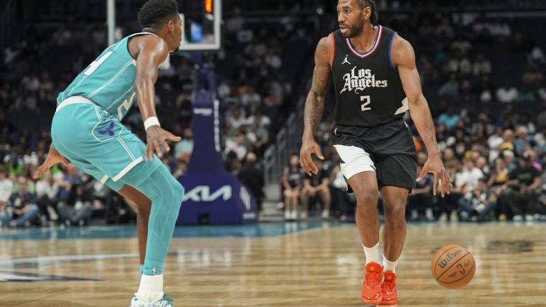 Mar 31, 2024; Charlotte, North Carolina, USA; LA Clippers forward Kawhi Leonard (2) on the dribble against Charlotte Hornets forward Brandon Miller (24) during the second half at Spectrum Center. Mandatory Credit: Jim Dedmon-USA TODAY Sports