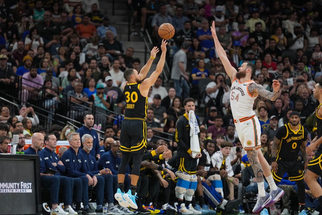 Mar 31, 2024; San Antonio, Texas, USA;  San Antonio Spurs forward Julian Champagnie (30) shoots over San Antonio Spurs forward Sandro Mamukelashvili (54) in the second half at Frost Bank Center. Mandatory Credit: Daniel Dunn-USA TODAY Sports