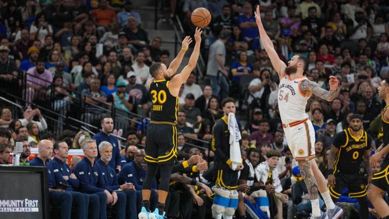 Mar 31, 2024; San Antonio, Texas, USA;  San Antonio Spurs forward Julian Champagnie (30) shoots over San Antonio Spurs forward Sandro Mamukelashvili (54) in the second half at Frost Bank Center. Mandatory Credit: Daniel Dunn-USA TODAY Sports