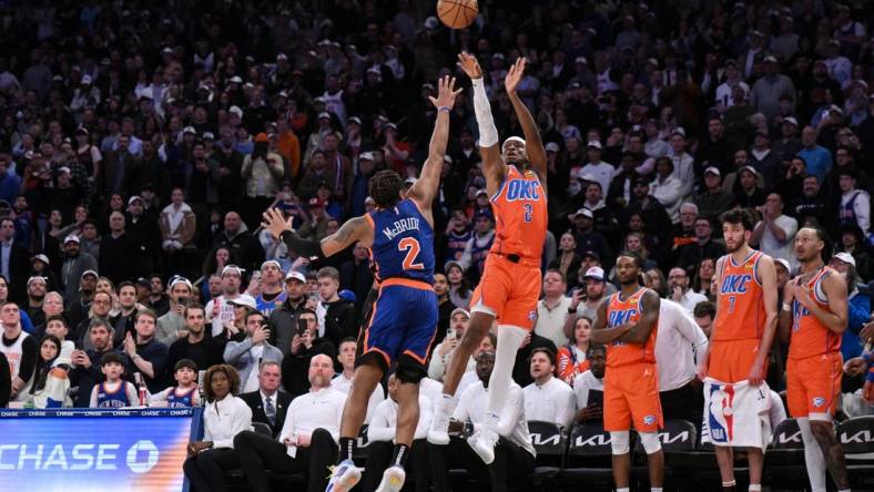 Mar 31, 2024; New York, New York, USA; Oklahoma City Thunder guard Shai Gilgeous-Alexander (2) hits the game winning basket with 1.8 seconds remaining in the fourth quarter while being defended by New York Knicks guard Miles McBride (2) at Madison Square Garden. Mandatory Credit: John Jones-USA TODAY Sports