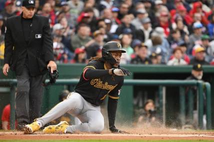 Apr 1, 2024; Washington, District of Columbia, USA; Pittsburgh Pirates shortstop Oneil Cruz (15) slides into home to score a run against the Washington Nationals at Nationals Park. Mandatory Credit: Rafael Suanes-USA TODAY Sports