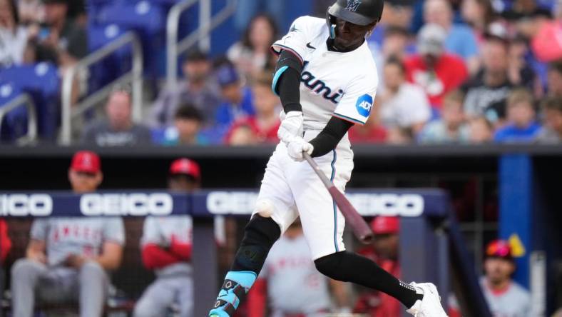 Apr 1, 2024; Miami, Florida, USA; Miami Marlins left fielder Nick Gordon (1) hits a single against the Los Angeles Angels during the first inning at loanDepot Park. Mandatory Credit: Rich Storry-USA TODAY Sports