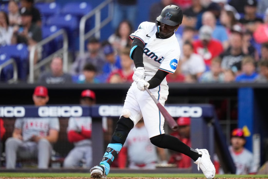 Apr 1, 2024; Miami, Florida, USA; Miami Marlins left fielder Nick Gordon (1) hits a single against the Los Angeles Angels during the first inning at loanDepot Park. Mandatory Credit: Rich Storry-USA TODAY Sports