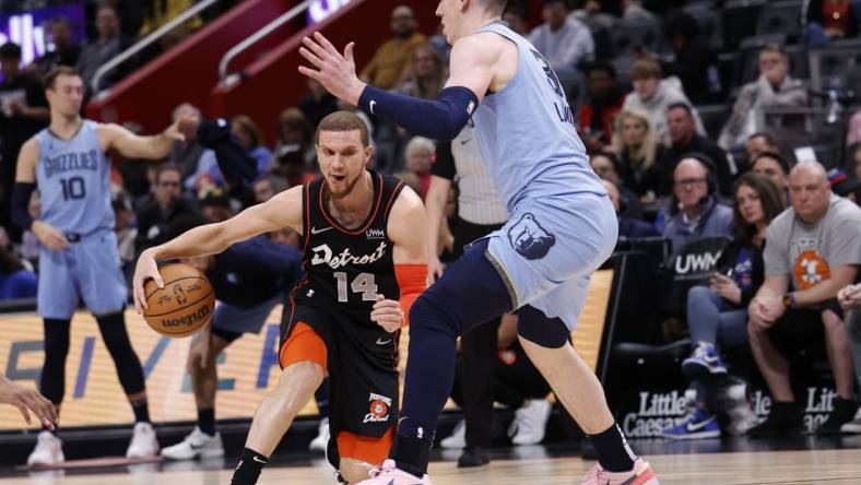 Apr 1, 2024; Detroit, Michigan, USA;  d14 dribbles defended by Memphis Grizzlies forward Jake LaRavia (3) in the first half at Little Caesars Arena. Mandatory Credit: Rick Osentoski-USA TODAY Sports