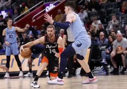 Apr 1, 2024; Detroit, Michigan, USA;  d14 dribbles defended by Memphis Grizzlies forward Jake LaRavia (3) in the first half at Little Caesars Arena. Mandatory Credit: Rick Osentoski-USA TODAY Sports