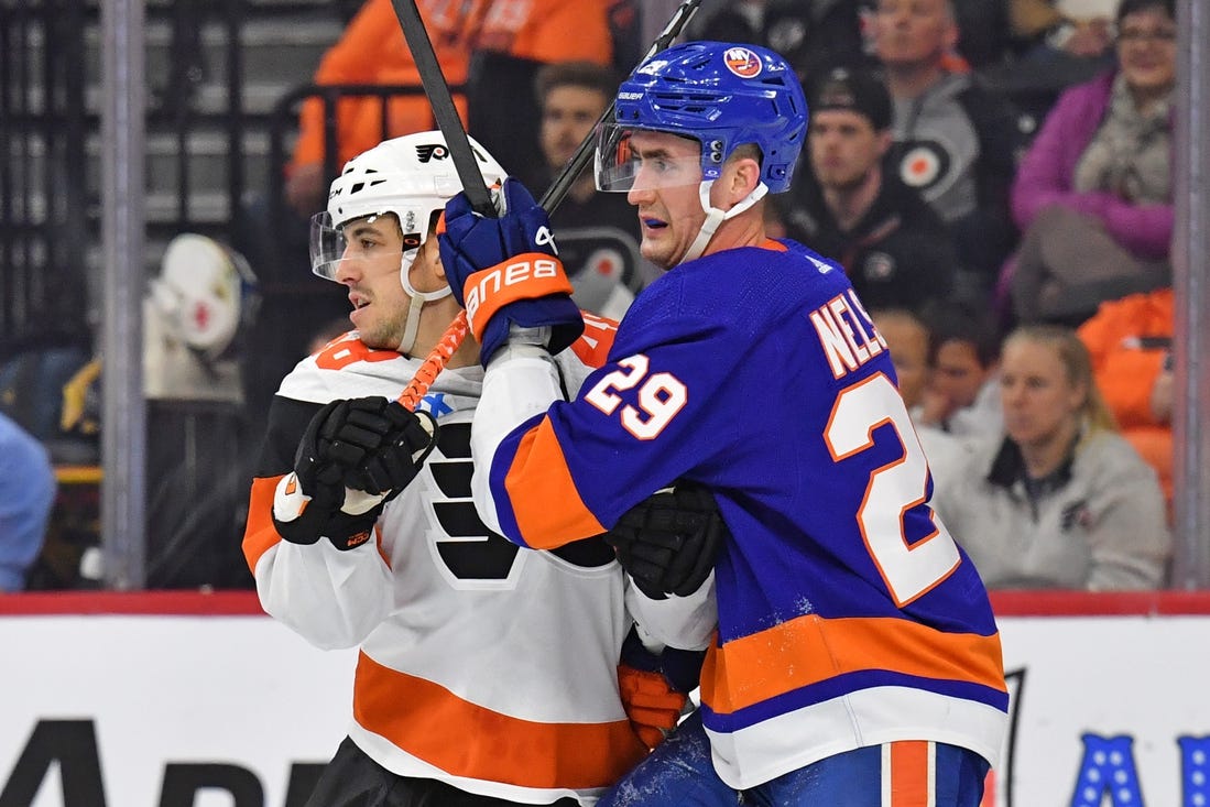 Apr 1, 2024; Philadelphia, Pennsylvania, USA; Philadelphia Flyers center Morgan Frost (48) and New York Islanders center Brock Nelson (29) battle for position during the second period at Wells Fargo Center. Mandatory Credit: Eric Hartline-USA TODAY Sports