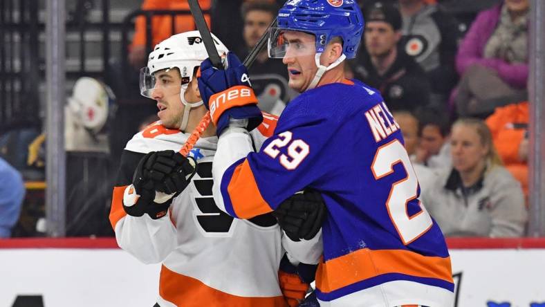 Apr 1, 2024; Philadelphia, Pennsylvania, USA; Philadelphia Flyers center Morgan Frost (48) and New York Islanders center Brock Nelson (29) battle for position during the second period at Wells Fargo Center. Mandatory Credit: Eric Hartline-USA TODAY Sports