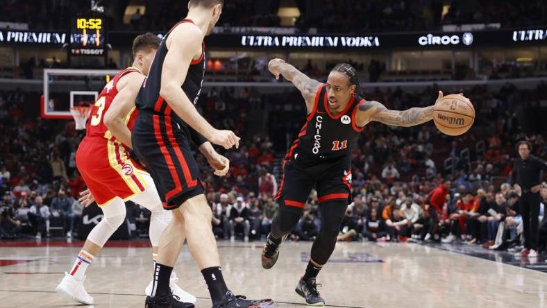 Apr 1, 2024; Chicago, Illinois, USA; Chicago Bulls forward DeMar DeRozan (11) tries to control the ball against the Atlanta Hawks during the first half at United Center. Mandatory Credit: Kamil Krzaczynski-USA TODAY Sports