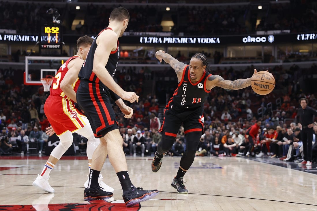 Apr 1, 2024; Chicago, Illinois, USA; Chicago Bulls forward DeMar DeRozan (11) tries to control the ball against the Atlanta Hawks during the first half at United Center. Mandatory Credit: Kamil Krzaczynski-USA TODAY Sports