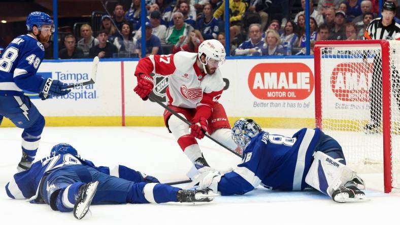 Apr 1, 2024; Tampa, Florida, USA;Tampa Bay Lightning goaltender Andrei Vasilevskiy (88) makes a save from Detroit Red Wings center Michael Rasmussen (27) during the second period at Amalie Arena. Mandatory Credit: Kim Klement Neitzel-USA TODAY Sports