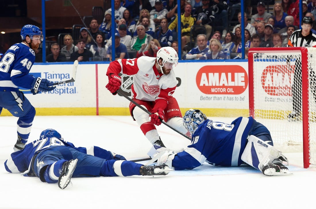 Apr 1, 2024; Tampa, Florida, USA;Tampa Bay Lightning goaltender Andrei Vasilevskiy (88) makes a save from Detroit Red Wings center Michael Rasmussen (27) during the second period at Amalie Arena. Mandatory Credit: Kim Klement Neitzel-USA TODAY Sports