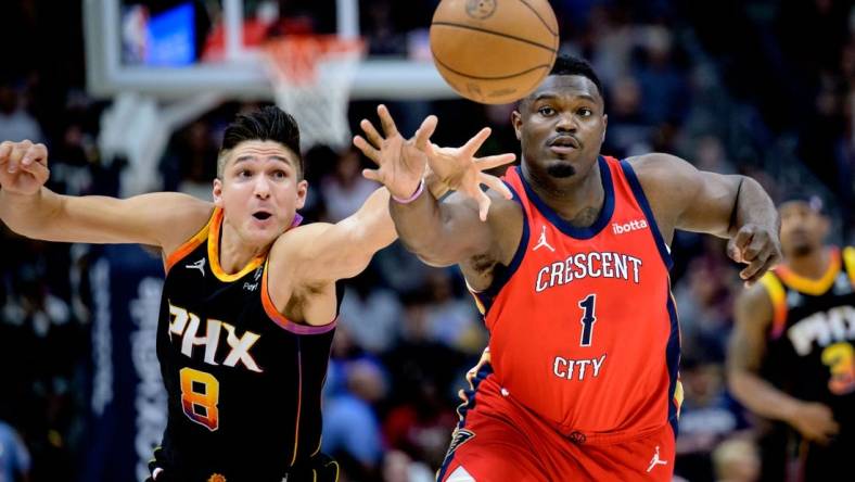 Apr 1, 2024; New Orleans, Louisiana, USA; New Orleans Pelicans forward Zion Williamson (1) battles Phoenix Suns guard Grayson Allen (8) for the ball during the first quarter at Smoothie King Center. Mandatory Credit: Matthew Hinton-USA TODAY Sports