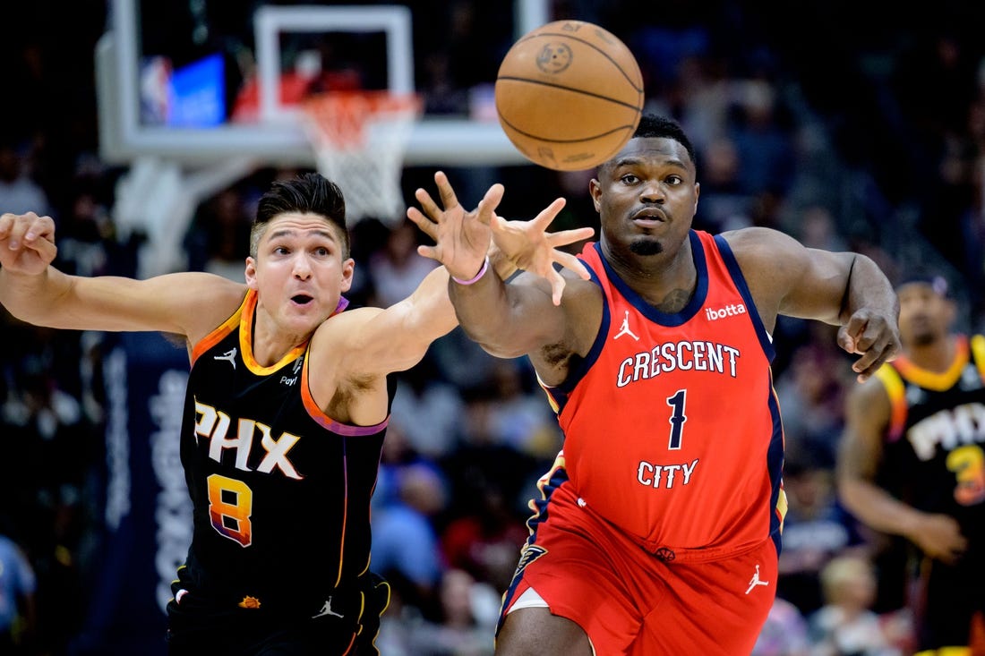 Apr 1, 2024; New Orleans, Louisiana, USA; New Orleans Pelicans forward Zion Williamson (1) battles Phoenix Suns guard Grayson Allen (8) for the ball during the first quarter at Smoothie King Center. Mandatory Credit: Matthew Hinton-USA TODAY Sports