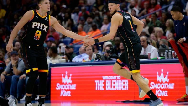 Apr 1, 2024; New Orleans, Louisiana, USA; Phoenix Suns guard Devin Booker (1) celebrates with Phoenix Suns guard Grayson Allen (8) against the New Orleans Pelicans during the first half at Smoothie King Center. Mandatory Credit: Matthew Hinton-USA TODAY Sports