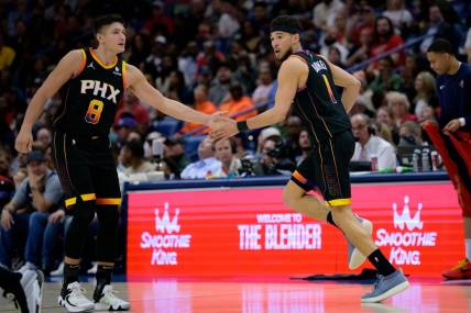 Apr 1, 2024; New Orleans, Louisiana, USA; Phoenix Suns guard Devin Booker (1) celebrates with Phoenix Suns guard Grayson Allen (8) against the New Orleans Pelicans during the first half at Smoothie King Center. Mandatory Credit: Matthew Hinton-USA TODAY Sports