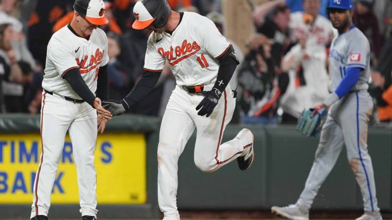 Apr 1, 2024; Baltimore, Maryland, USA; Baltimore Orioles designated hitter Jordan Westburg (11) greeted by coach Tony Mansolino (36) following his game winning two run home run in the ninth inning against the Kansas City Royals at Oriole Park at Camden Yards. Mandatory Credit: Mitch Stringer-USA TODAY Sports