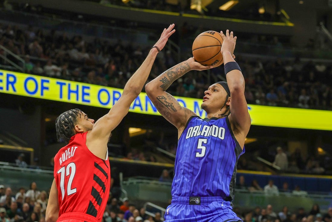 Apr 1, 2024; Orlando, Florida, USA; Orlando Magic forward Paolo Banchero (5) shoots the ball against Portland Trail Blazers guard Rayan Rupert (72) during the second half at Amway Center. Mandatory Credit: Mike Watters-USA TODAY Sports