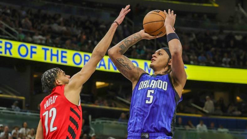 Apr 1, 2024; Orlando, Florida, USA; Orlando Magic forward Paolo Banchero (5) shoots the ball against Portland Trail Blazers guard Rayan Rupert (72) during the second half at Amway Center. Mandatory Credit: Mike Watters-USA TODAY Sports