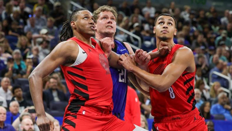 Apr 1, 2024; Orlando, Florida, USA; Portland Trail Blazers forward Jabari Walker (34) forward Kris Murray (8) and Orlando Magic center Moritz Wagner (21) look for the rebound during the second half at Amway Center. Mandatory Credit: Mike Watters-USA TODAY Sports