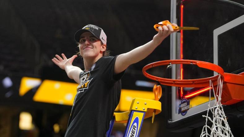 Apr 1, 2024; Albany, NY, USA; Iowa Hawkeyes guard Caitlin Clark (22) cuts the net after defeating the LSU Lady Tigers in the finals of the Albany Regional in the 2024 NCAA Tournament at MVP Arena. Mandatory Credit: Gregory Fisher-USA TODAY Sports