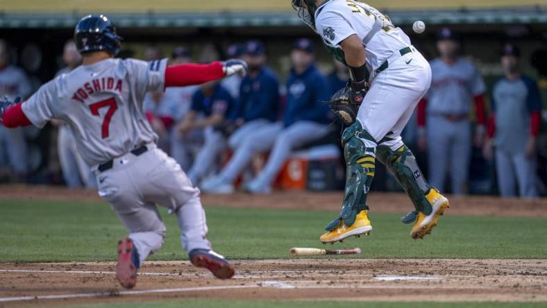 Apr 1, 2024; Oakland, California, USA; Boston Red Sox left fielder Masataka Yoshida (7) scores on the throw to Oakland Athletics catcher Shea Langeliers (23) during the second inning at Oakland-Alameda County Coliseum. Mandatory Credit: Neville E. Guard-USA TODAY Sports