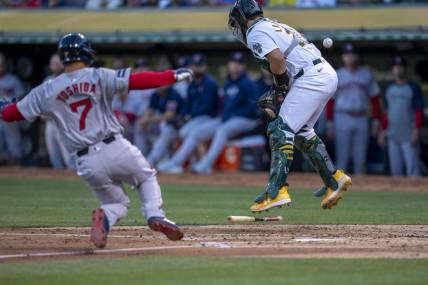 Apr 1, 2024; Oakland, California, USA; Boston Red Sox left fielder Masataka Yoshida (7) scores on the throw to Oakland Athletics catcher Shea Langeliers (23) during the second inning at Oakland-Alameda County Coliseum. Mandatory Credit: Neville E. Guard-USA TODAY Sports