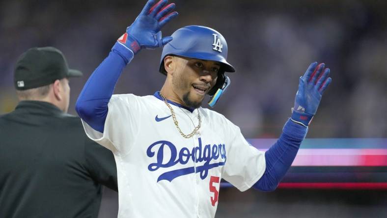 Apr 1, 2024; Los Angeles, California, USA; Los Angeles Dodgers shortstop Mookie Betts (50) reacts after hitting a triple in the first inning against the San Francisco Giants at Dodger Stadium. Mandatory Credit: Kirby Lee-USA TODAY Sports