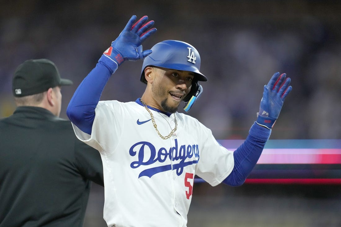 Apr 1, 2024; Los Angeles, California, USA; Los Angeles Dodgers shortstop Mookie Betts (50) reacts after hitting a triple in the first inning against the San Francisco Giants at Dodger Stadium. Mandatory Credit: Kirby Lee-USA TODAY Sports