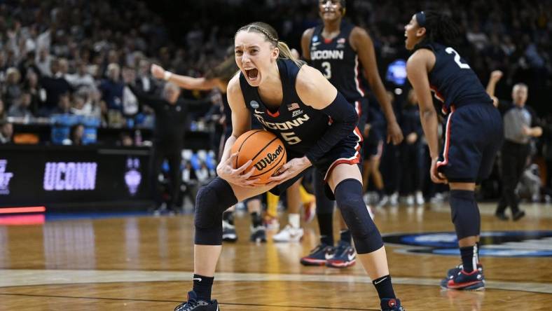 UConn Huskies guard Paige Bueckers (5) celebrates after beating the USC Trojans in the finals of the Portland Regional of the NCAA Tournament at the Moda Center. Mandatory Credit: Troy Wayrynen-USA TODAY Sports