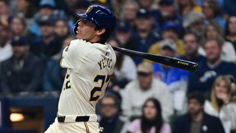 Apr 2, 2024; Milwaukee, Wisconsin, USA; Milwaukee Brewers left fielder Christian Yelich (22) hits a solo home run in the third inning against the Minnesota Twins at American Family Field. Mandatory Credit: Benny Sieu-USA TODAY Sports