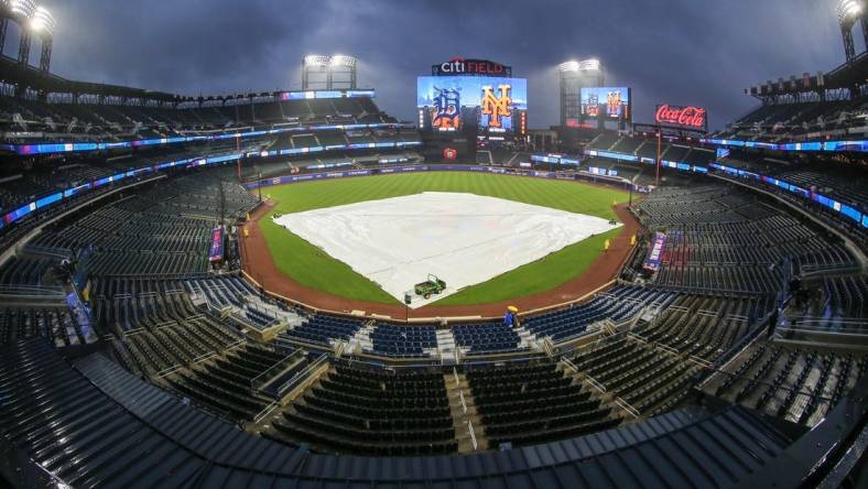 Apr 2, 2024; New York City, New York, USA;  The tarp is placed on the field during a rain delay prior to the game between the Detroit Tigers and the New York Mets at Citi Field. Mandatory Credit: Wendell Cruz-USA TODAY Sports