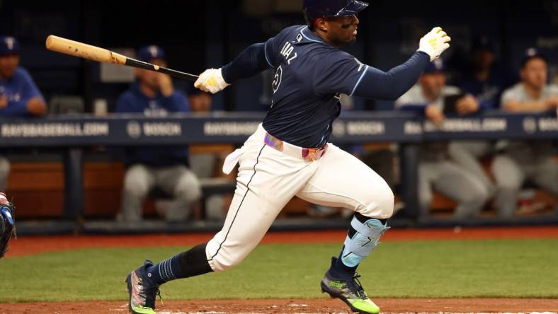 Apr 2, 2024; St. Petersburg, Florida, USA; Tampa Bay Rays first baseman Yandy Diaz (2) hits a RBI single during the third inning against the Texas Rangers at Tropicana Field. Mandatory Credit: Kim Klement Neitzel-USA TODAY Sports