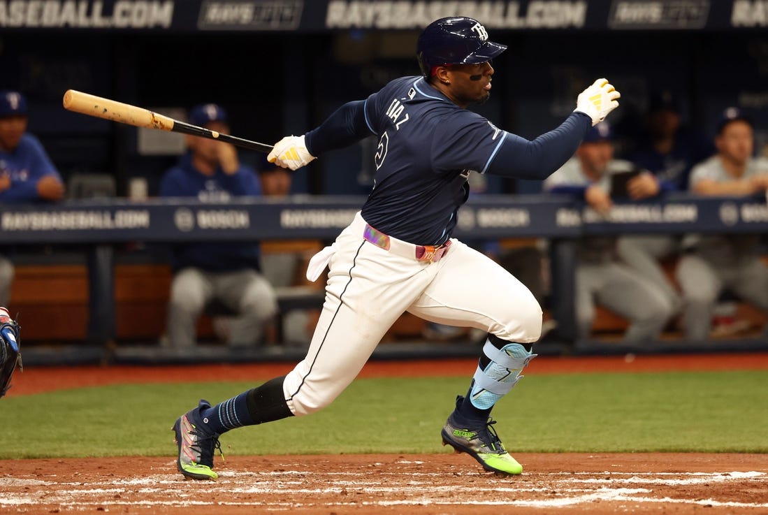 Apr 2, 2024; St. Petersburg, Florida, USA; Tampa Bay Rays first baseman Yandy Diaz (2) hits a RBI single during the third inning against the Texas Rangers at Tropicana Field. Mandatory Credit: Kim Klement Neitzel-USA TODAY Sports