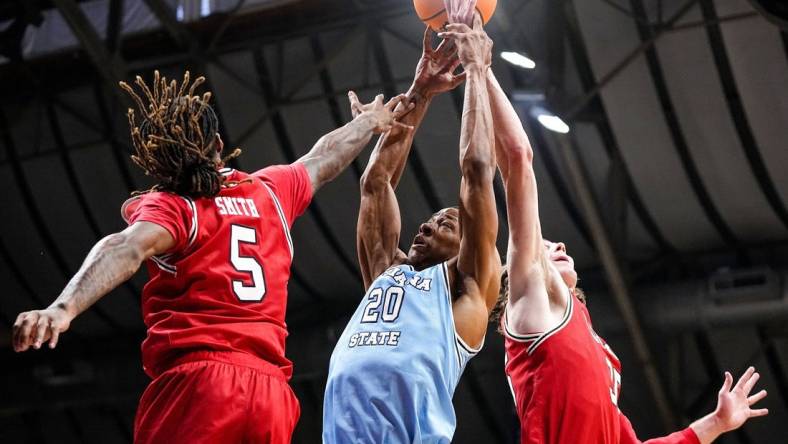 Indiana State Sycamores guard Jayson Kent (20) reaches for the ball against Utah Utes guard Deivon Smith (5) on Tuesday, April 2, 2024, during the NIT semifinals at Hinkle Fieldhouse in Indianapolis.