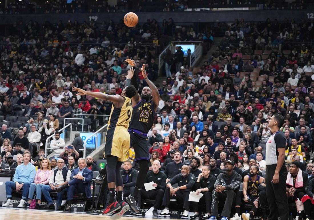 Apr 2, 2024; Toronto, Ontario, CAN; Los Angeles Lakers forward LeBron James (23) shoots the ball at the basket as Toronto Raptors guard RJ Barrett (9) tries to defend  during the second quarter at Scotiabank Arena. Mandatory Credit: Nick Turchiaro-USA TODAY Sports