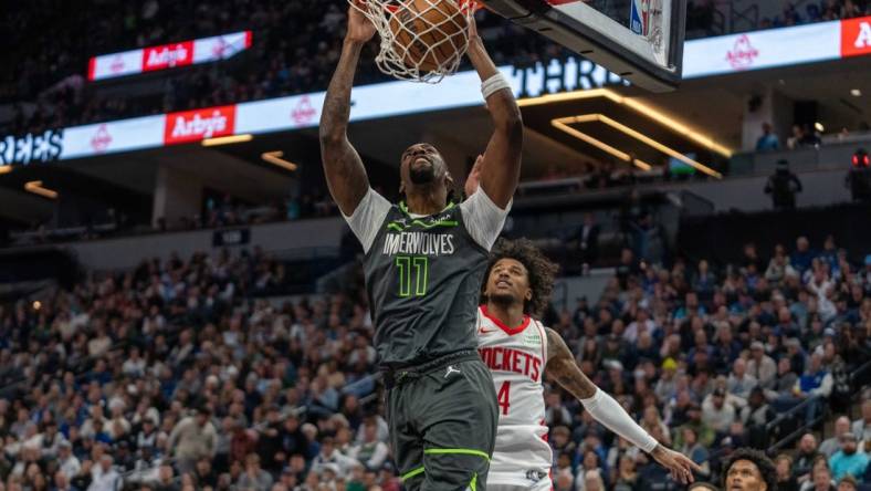 Apr 2, 2024; Minneapolis, Minnesota, USA; Minnesota Timberwolves center Naz Reid (11) dunks over Houston Rockets guard Jalen Green (4) in the second quarter at Target Center. Mandatory Credit: Matt Blewett-USA TODAY Sports